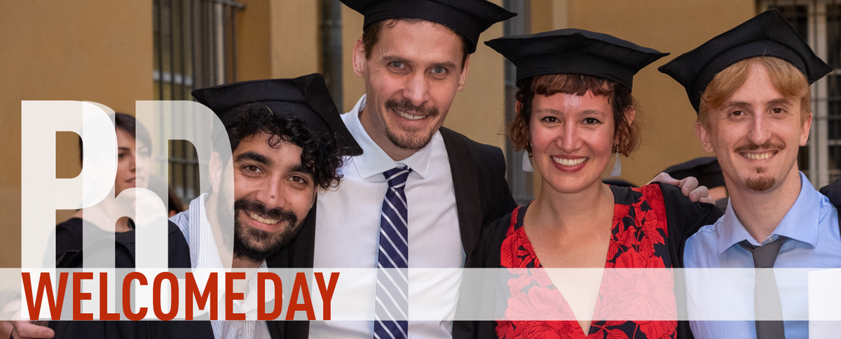 PhD Welcome Day. A PhD student wearing cap and gown smiles on the graduation day.